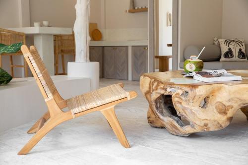 a wooden chair and a table in a living room at Cielo Boutique Hotel & Spa Samui in Bophut 