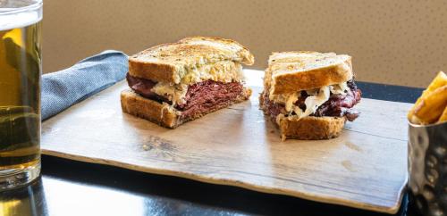 a sandwich is cut in half on a cutting board at Pittsburgh Marriott City Center in Pittsburgh
