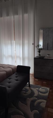 a living room with a couch and a mirror at Giardino Massari in Lecce