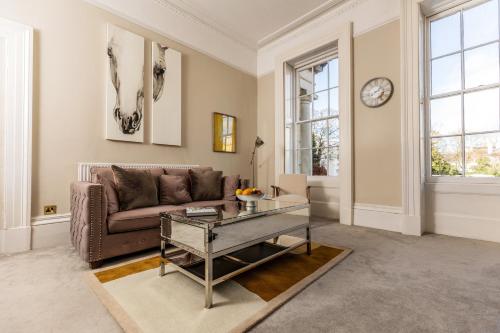 a living room with a couch and a table at Luxury Apartment - 18 Lansdown Crescent in Cheltenham
