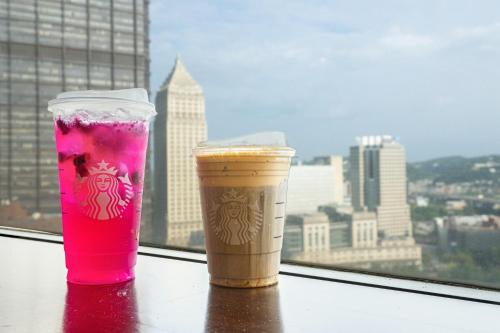 two drinks sitting on a table in front of a window at Pittsburgh Marriott City Center in Pittsburgh