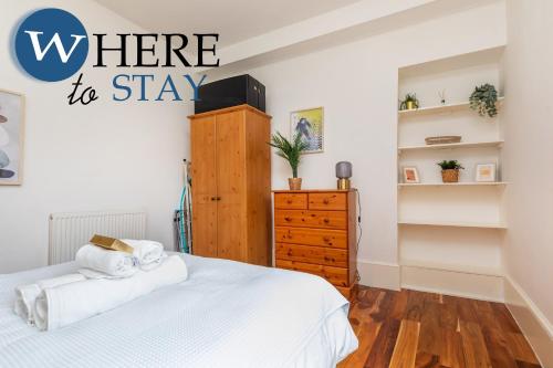 a bedroom with a bed and a dresser with the words where to stay at Lovely Aberdeen Apartment, Free Parking, River Side in Aberdeen