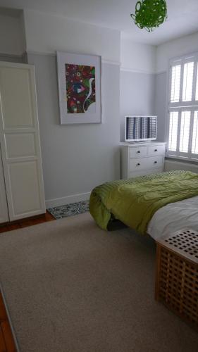 a white bedroom with a bed and a window at London 2 Bed Flat Zone2 in London