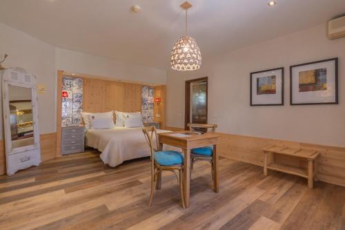 a bedroom with a bed and a desk and a table at Villas D. Dinis - Charming Residence (adults only) in Lagos
