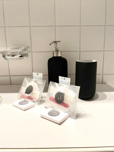 a bathroom counter with two bags of soap and a bottle at Cozy apartment in St. Moritz in St. Moritz