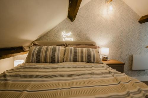 a large bed in a room with aigiligiligil at The Cow Shed at Pencraig in Holyhead