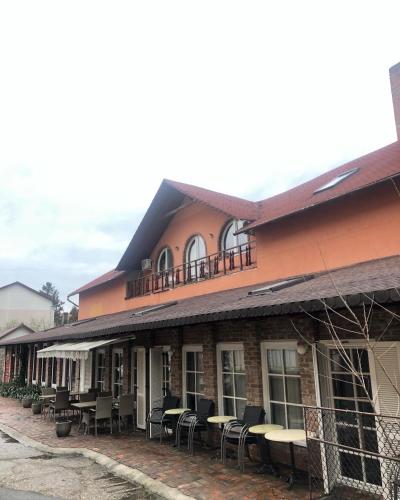 a building with tables and chairs in front of it at Vila Restaurant Sofia in Marghita