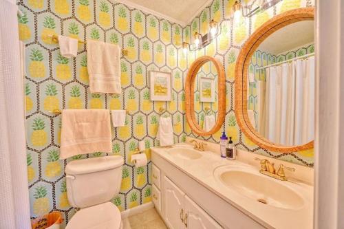 a bathroom with a sink and a toilet and a mirror at Ocean Getaway, Near Beach, 8ppl in Myrtle Beach