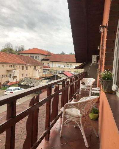 a balcony with chairs and a view of a city at Vila Restaurant Sofia in Marghita