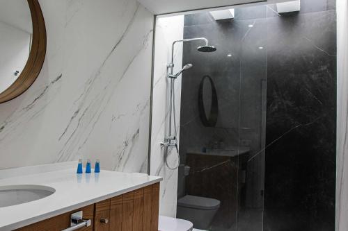 a bathroom with a shower with a toilet and a sink at Amor A Mar Dolphin in Puerto del Carmen