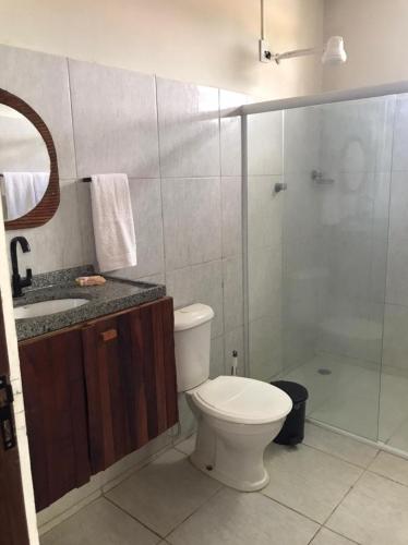 a bathroom with a toilet and a sink and a shower at Pousada da Sami in Barra de São Miguel