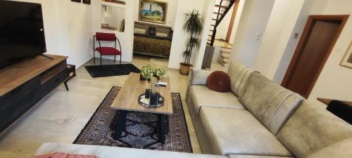 a living room with a couch and a coffee table at La Maisonette, Florina Center in Florina