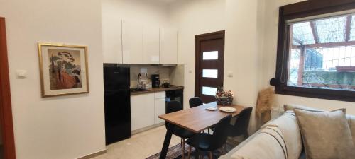 a living room with a couch and a table and a kitchen at La Maisonette, Florina Center in Florina