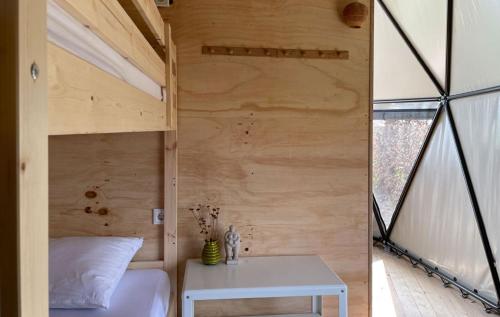 a bedroom with a bed and a table in a room at Camping de Vliert in Bunnik