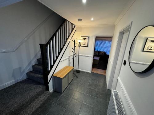 a stairway with a wooden bench in a house at Station house in Ramsgate