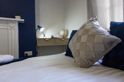 a bed with a large pillow sitting on top of it at Studio apartment - The Sapphire 