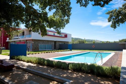 a swimming pool in the backyard of a house at Hotel Santa Margarida in Oleiros