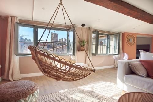 a living room with a hammock hanging from the ceiling at Paul Riquet 1609 City Center Residences in Béziers