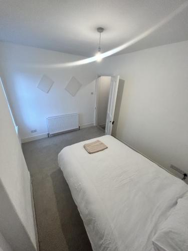 a bedroom with a white bed in a room at Canvas House in Carlisle