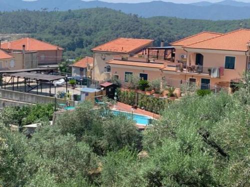 a house with a swimming pool in a village at Gli Angeli Agriturismo - Zia Rosa in Cisano sul Neva