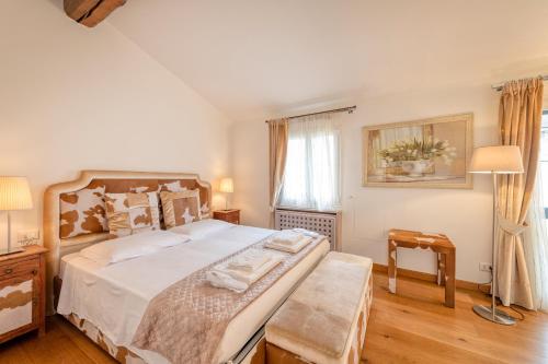 a bedroom with a large bed and a window at Milan Royal Suites - Castello in Milan