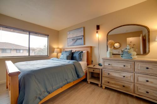a bedroom with a bed and a mirror and a dresser at Centrally Located Sparks Condo with Private Patio! in Sparks