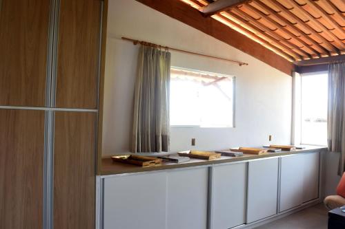 a room with a counter with books on it at Casa de Lala Beach House in São Miguel do Gostoso