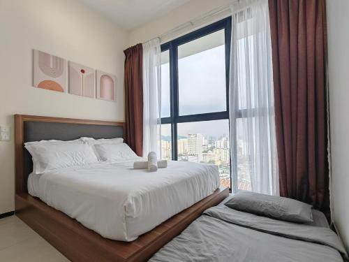 a bedroom with two beds and a large window at Cityscape Haven - Explore George Town, Komtar & UNESCO in Jelutong