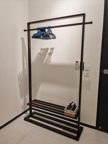 a glass display case with shoes on a shelf at Cityscape Haven - Urban Suites by Ocean Luxe in Jelutong