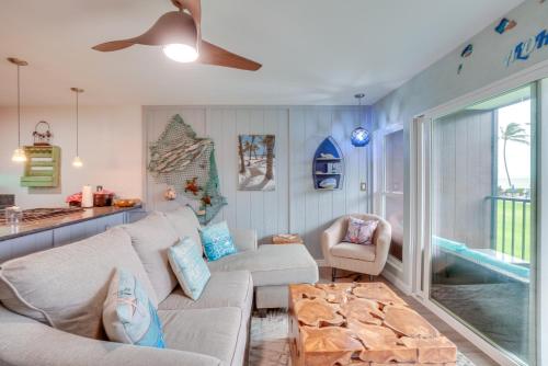 a living room with a couch and a table at Coastal Kaunakakai Condo with Ocean-View Balcony! in Kaunakakai
