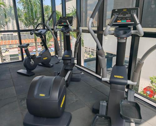 a row of exercise bikes in a gym at Cityscape Haven - Urban Suites by Ocean Luxe in Jelutong