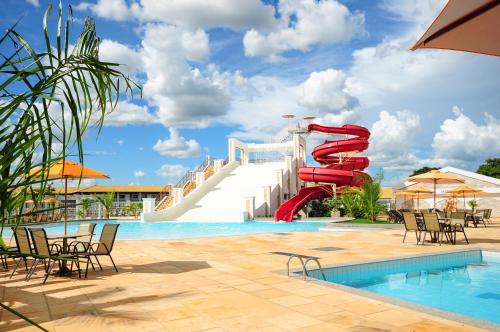a resort pool with a red water slide at Lacqua diRoma III - MF in Caldas Novas