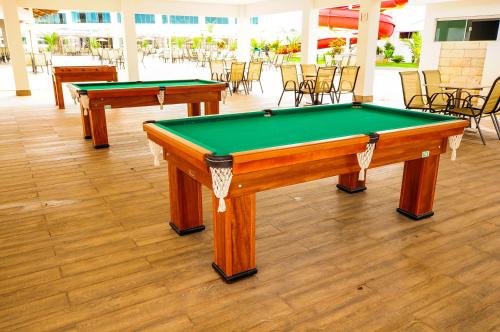 two pool tables in a room with chairs at Lacqua diRoma III - MF in Caldas Novas