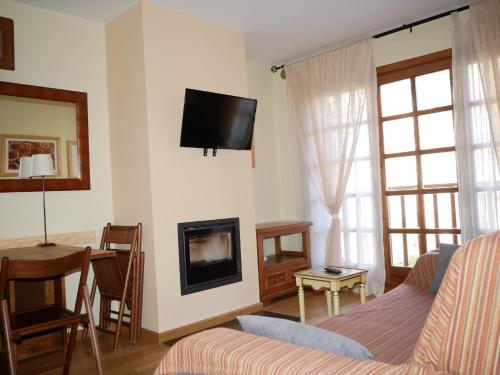 a living room with a couch and a fireplace at Francoli-Vacances Pirinenca in Canillo