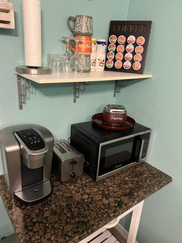 a counter with a microwave and a coffee maker and a toaster at La Adventura Villa in Seminole