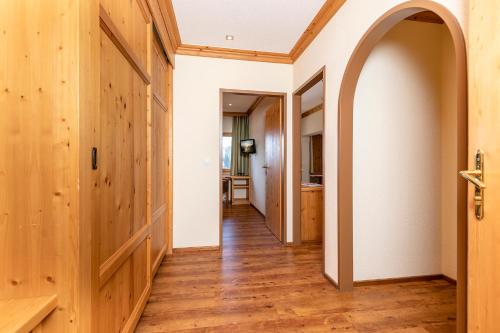 an open hallway with wood floors and an archway at Hotel Landgasthof Gappen in Kramsach