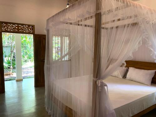 Ένα ή περισσότερα κρεβάτια σε δωμάτιο στο Kithul house