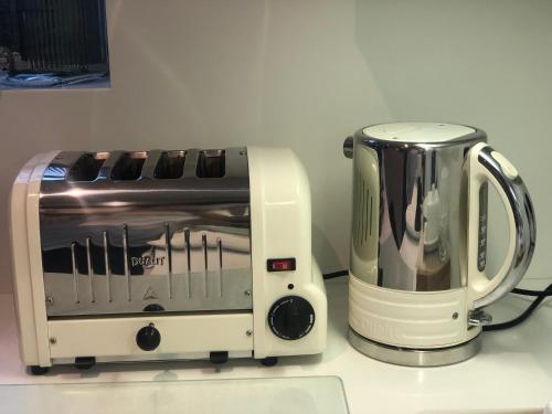 a toaster and a coffee maker on a counter at Perfect Pad for Solo Travelers in Norwood