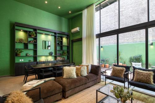 a living room with a couch and a table at Colorful & Lively Centro Gem 5BR, Rooftop Patio in San Miguel de Allende