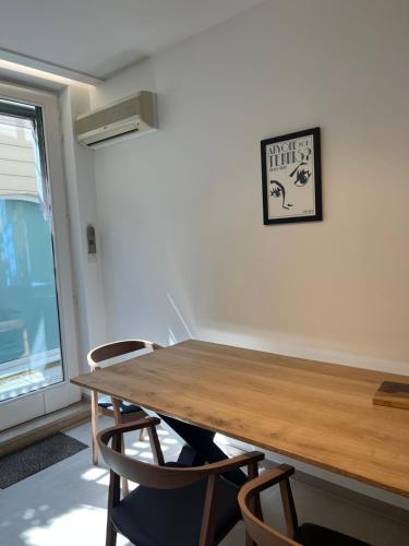 a dining room table with chairs and a clock on the wall at Markt 5 in Lier