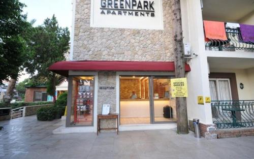 a store front of a building with a red awning at GREENPARK APARTMENTS in Marmaris