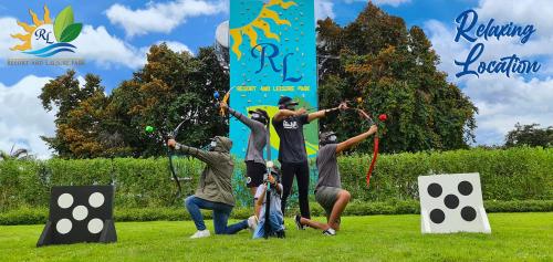 a group of people playing hopscotch in the grass at RL RESORT AND LEISURE PARK in Porac