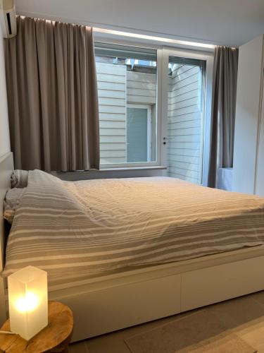 a bedroom with a large bed and a window at Markt 5 in Lier