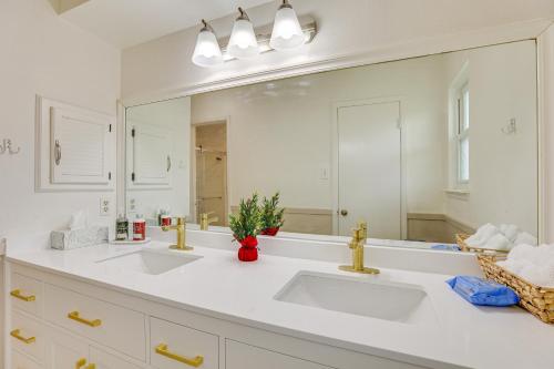 a bathroom with two sinks and a large mirror at Houston Home with Screened Porch, Near Sugar Land! in Houston