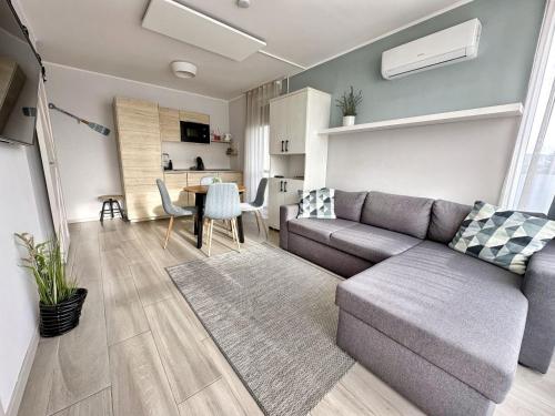 a living room with a couch and a table at Marina Apartment by Dora in Keszthely