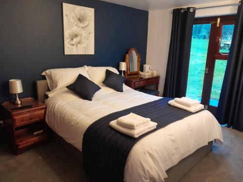 a bedroom with a large bed with towels on it at Ye Olde Bowling Green Inn in Bradwell