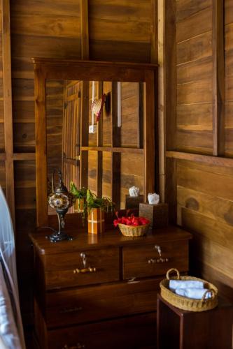 a wooden room with a mirror and a dresser at Wanakaset Forest Glamping in Kitulgala