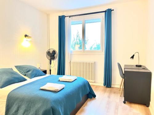 a bedroom with a blue bed and a window at Stay house to Poitiers in Poitiers