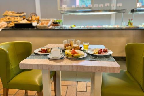 a table with two plates of food on it at Bungalows Cordial Green Golf in Maspalomas