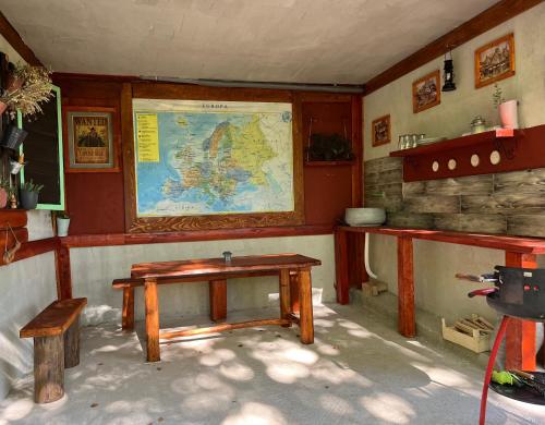 a room with a table and a map on the wall at Mountain apartment ''Michelle'' in Kakanj